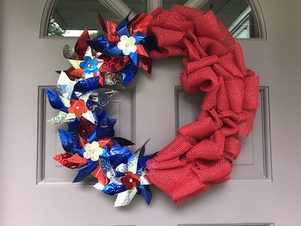 You'll love easy-to-make patriotic wreaths to decorate your door for the Fourth of July! Can you believe these wreaths are made with craft supplies from the dollar store?!?! Be sure to stash your wreath somewhere convenient so you can hang it again for Labor Day and Memorial Day. 