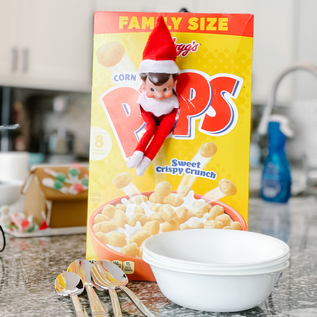 Easy elf ideas - The elf helps get cereal out for breakfast and gets stuck in the cereal box! 